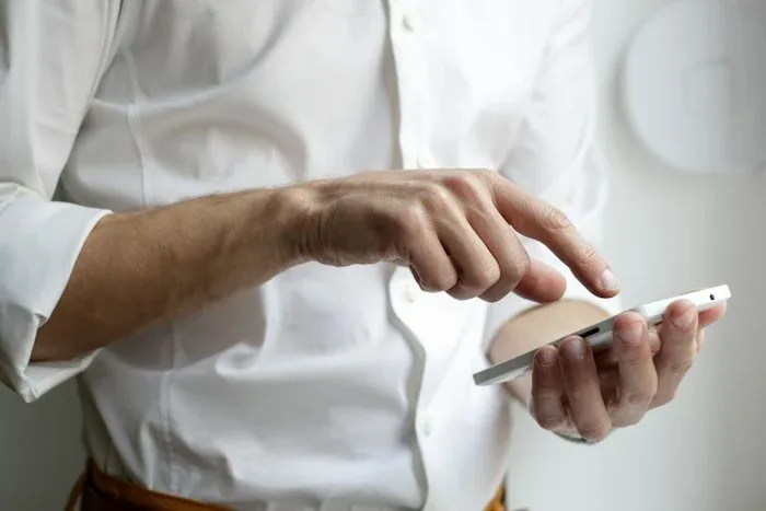digital marketing agency in Kakinada Using a smartphone for customer messaging